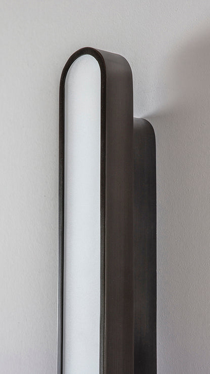Capsule Wall Light dark bronze, detailed close up view of finish.