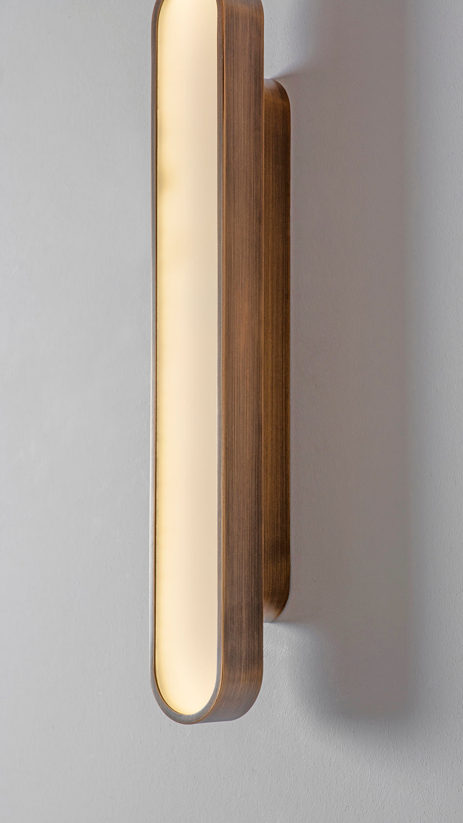 Capsule Wall Light bronze, detailed close up view of finish, on
