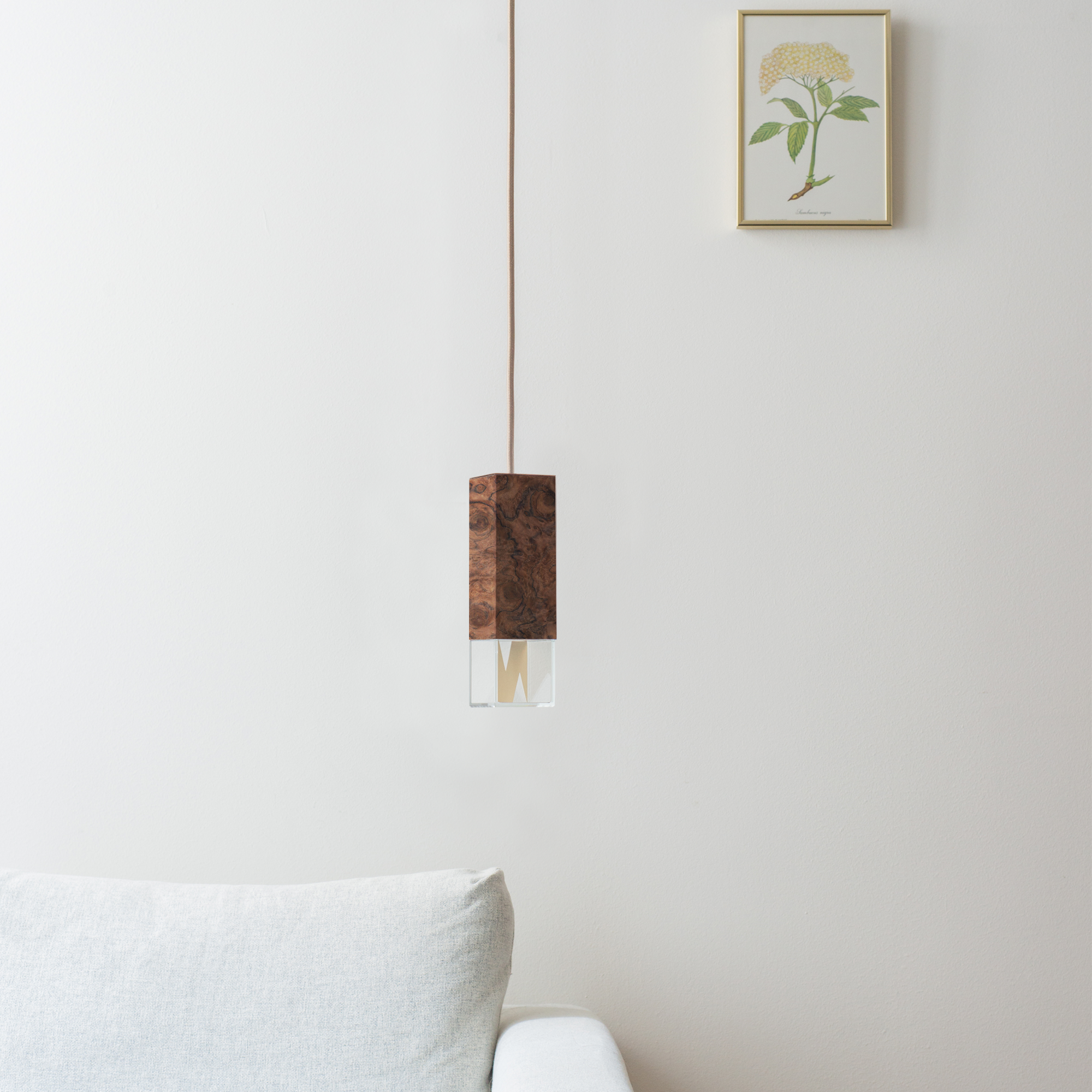 Lamp One Pendant Light / Wood, hanging from ceiling in living room setting.