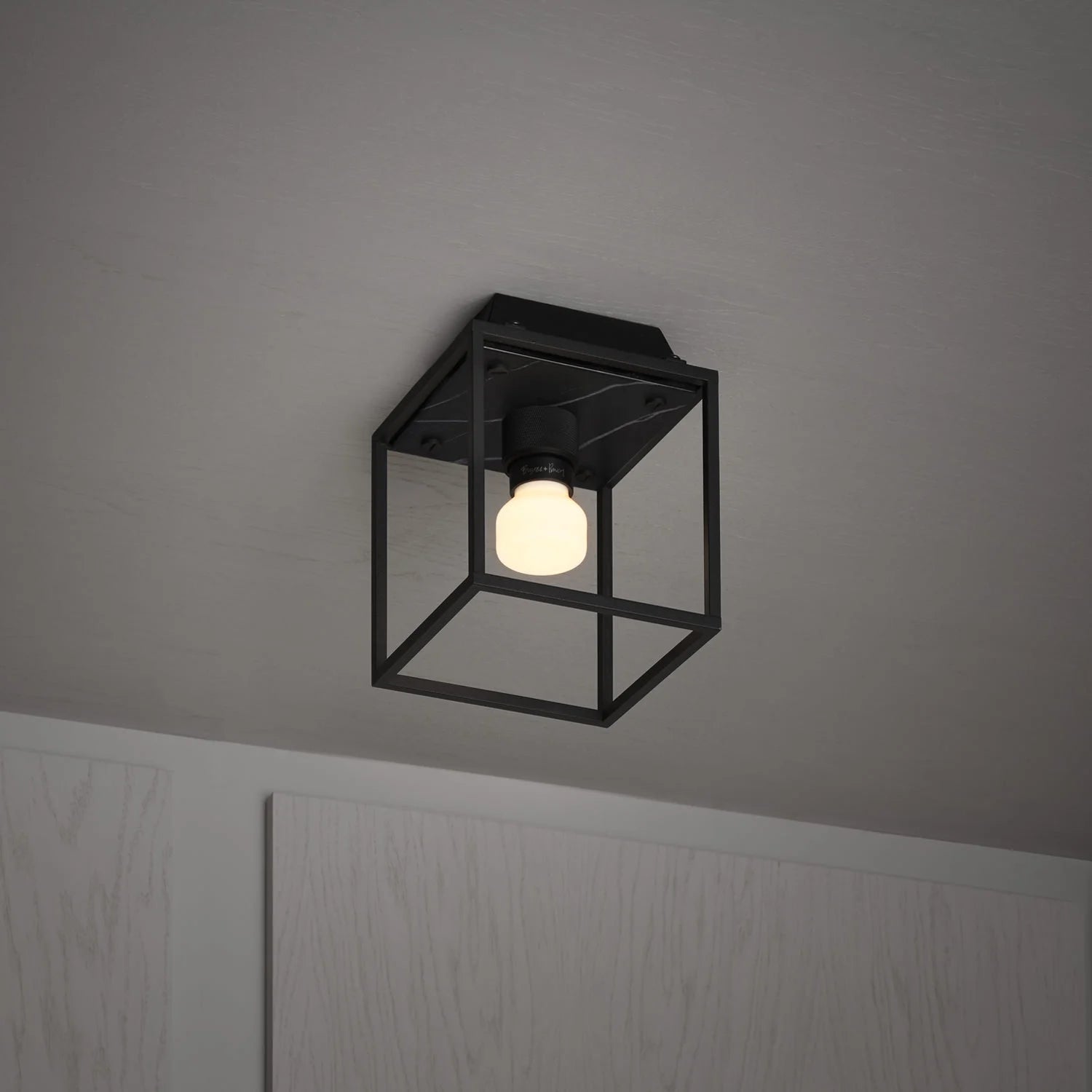 Caged Ceiling Light / Small in black marble, on side view.